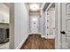 Inviting hallway with hardwood floors, white trim, and doors leading to other rooms at 1891 Felts Pkwy, Fort Mill, SC 29715