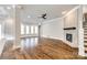 Spacious living room featuring hardwood floors, a brick fireplace, recessed lighting, and large windows at 1891 Felts Pkwy, Fort Mill, SC 29715