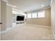 This living room has built in shelving, three windows, and neutral colored walls at 1891 Felts Pkwy, Fort Mill, SC 29715