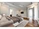 Comfortable main bedroom boasting a tray ceiling, recessed lights, adjoining bath, and access to another room at 1891 Felts Pkwy, Fort Mill, SC 29715