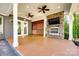 Covered outdoor living area featuring a stone fireplace, ceiling fans, tv, and roll down blinds for ultimate privacy at 1891 Felts Pkwy, Fort Mill, SC 29715