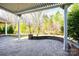Covered patio featuring stone retaining wall and shade from the sun to enjoy the beauty of the outdoors at 1891 Felts Pkwy, Fort Mill, SC 29715