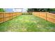Spacious backyard with a well-maintained lawn and wood fencing at 1922 Hamorton Pl, Charlotte, NC 28205