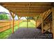 View of backyard under deck with grass and wooden fence at 1922 Hamorton Pl, Charlotte, NC 28205
