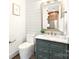 Charming powder room with a marble countertop, green vanity, stylish mirror, and ship lap wall at 1922 Hamorton Pl, Charlotte, NC 28205