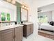 Bright bathroom showcasing double vanities with stylish mirrors, shiplap accent wall, and marble floors leading to bedroom at 1922 Hamorton Pl, Charlotte, NC 28205