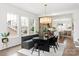 Bright dining room with a modern table and decor adjacent to the kitchen with hardwood floors at 1922 Hamorton Pl, Charlotte, NC 28205