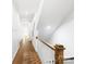 Inviting hallway with beautiful hardwood floors, wainscoting, and modern lighting, leading to various rooms at 1922 Hamorton Pl, Charlotte, NC 28205