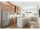 Modern kitchen with light wood cabinets, a large island, stainless steel appliances, and white countertops at 1922 Hamorton Pl, Charlotte, NC 28205