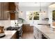 Modern kitchen with stainless steel appliances, white countertops, and light wood cabinets at 1922 Hamorton Pl, Charlotte, NC 28205