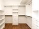 Spacious walk-in closet featuring custom shelves, drawers, and ample hanging space for organized storage at 1922 Hamorton Pl, Charlotte, NC 28205