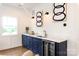 Bright wet bar area with blue cabinets and a beverage cooler at 1922 Hamorton Pl, Charlotte, NC 28205