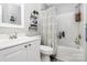 Well-lit bathroom featuring a shower-tub combo, vanity, and decorative shelves at 19613 Feriba Pl, Cornelius, NC 28031