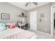 Bright, comfortable bedroom featuring a desk with storage and a ceiling fan for climate control at 19613 Feriba Pl, Cornelius, NC 28031