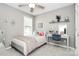Bright, comfortable bedroom featuring a desk with storage and a ceiling fan for climate control at 19613 Feriba Pl, Cornelius, NC 28031