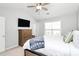 Bright bedroom featuring a ceiling fan, natural light, and modern furnishings at 19613 Feriba Pl, Cornelius, NC 28031
