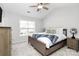 Cozy bedroom with a ceiling fan, neutral tones, and natural light from the window at 19613 Feriba Pl, Cornelius, NC 28031
