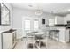 Bright dining area with white table, chandelier, and access to outdoor space at 19613 Feriba Pl, Cornelius, NC 28031
