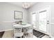 Bright dining area with white table, chandelier, and access to outdoor space at 19613 Feriba Pl, Cornelius, NC 28031