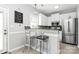 Modern kitchen with white cabinets, granite countertops, and stainless steel appliances at 19613 Feriba Pl, Cornelius, NC 28031