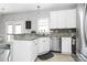 Charming kitchen with granite countertops, white cabinets, and stainless steel appliances at 19613 Feriba Pl, Cornelius, NC 28031