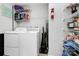 Functional laundry room with washer, dryer, shelving, and storage space at 19613 Feriba Pl, Cornelius, NC 28031
