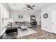 Cozy living room with a ceiling fan, gray sofa, and stylish decor at 19613 Feriba Pl, Cornelius, NC 28031