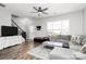 Open-concept living room with wood floors, staircase, and modern decor at 19613 Feriba Pl, Cornelius, NC 28031