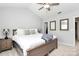 Comfortable bedroom featuring a ceiling fan, ensuite access, and neutral decor throughout at 19613 Feriba Pl, Cornelius, NC 28031