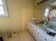 Bathroom with a double sink vanity, large mirror, and storage drawers at 1968 12Th Street Ne Pl, Hickory, NC 28601