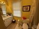 Well-lit bathroom with a single vanity, toilet, and framed artwork at 1968 12Th Street Ne Pl, Hickory, NC 28601