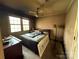 Bedroom with natural light from the window, ceiling fan, and hardwood floors at 1968 12Th Street Ne Pl, Hickory, NC 28601