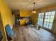 Open dining space with wood-look floors, view to the kitchen, and a sliding glass door at 1968 12Th Street Ne Pl, Hickory, NC 28601