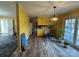 Open dining space with wood-look floors, view to the kitchen, and a sliding glass door at 1968 12Th Street Ne Pl, Hickory, NC 28601