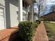 Close-up of a home's exterior showing a brick walkway bordered by lush, green shrubbery at 1968 12Th Street Ne Pl, Hickory, NC 28601