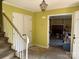 View of foyer with staircase and doorway to the living room with a fireplace at 1968 12Th Street Ne Pl, Hickory, NC 28601