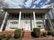 Exterior of a home featuring classic architectural details, a brick walkway, and manicured shrubbery at 1968 12Th Street Ne Pl, Hickory, NC 28601