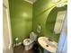 Cozy powder room with green walls, vanity, and toilet at 1968 12Th Street Ne Pl, Hickory, NC 28601