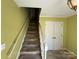 Carpeted staircase with a white handrail leading to the upper level of the home at 1968 12Th Street Ne Pl, Hickory, NC 28601