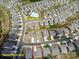 Aerial view of a neighborhood featuring a community pool, clubhouse, and neatly arranged homes at 2010 Saddlebred Dr, Iron Station, NC 28080