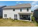 Large backyard with a covered patio, a black metal fence, and space for activities at 2010 Saddlebred Dr, Iron Station, NC 28080