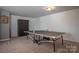 Large finished basement space featuring a ping pong table and ample storage, offering versatility and functionality at 2010 Saddlebred Dr, Iron Station, NC 28080