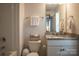 Bathroom including shower/tub combo, granite top vanity, toilet, and storage basket on the commode at 2010 Saddlebred Dr, Iron Station, NC 28080