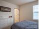 Bedroom with a bed and dresser, featuring neutral colors and ample natural light at 2010 Saddlebred Dr, Iron Station, NC 28080