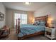 Cozy bedroom featuring a charming four-poster bed, soft blue bedding, and natural light streaming through the window at 2010 Saddlebred Dr, Iron Station, NC 28080