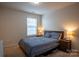 Cozy bedroom features a comfortable bed, side tables with lamps, and soft carpet at 2010 Saddlebred Dr, Iron Station, NC 28080