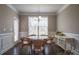 Bright dining room with hardwood floors, white trim, and a chandelier with area rug at 2010 Saddlebred Dr, Iron Station, NC 28080