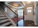 Welcoming foyer featuring tray ceilings, stairs and wainscoting for charm at 2010 Saddlebred Dr, Iron Station, NC 28080