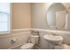 Clean half bathroom showcasing a pedestal sink, round mirror, and neutral decor at 2010 Saddlebred Dr, Iron Station, NC 28080