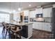 Modern kitchen with granite counters, stainless steel appliances, and an island with seating at 2010 Saddlebred Dr, Iron Station, NC 28080